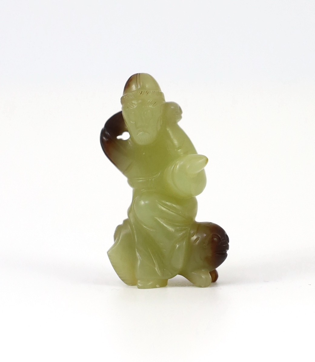 A Chinese yellow and brown jade figure of a man seated on a creature, 19th century, 4.3cm high